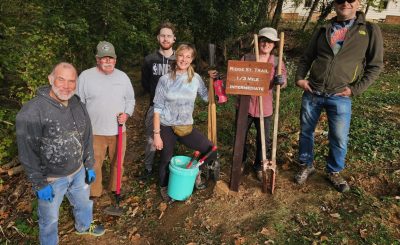 Volunteers from the Trail & Town Alliance install signs provided by the Harpers Ferry Parks & Recreation Commission on the Ridge Street Trail.