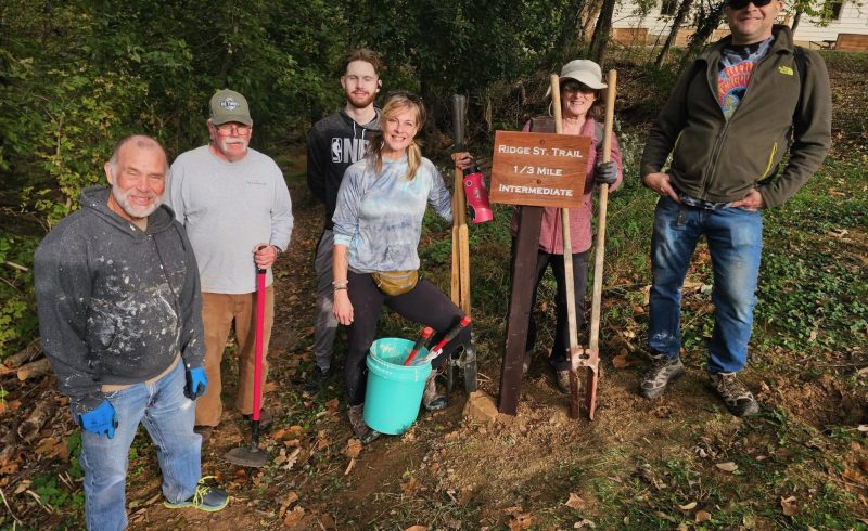 Volunteers from the Trail & Town Alliance install signs provided by the Harpers Ferry Parks & Recreation Commission on the Ridge Street Trail.